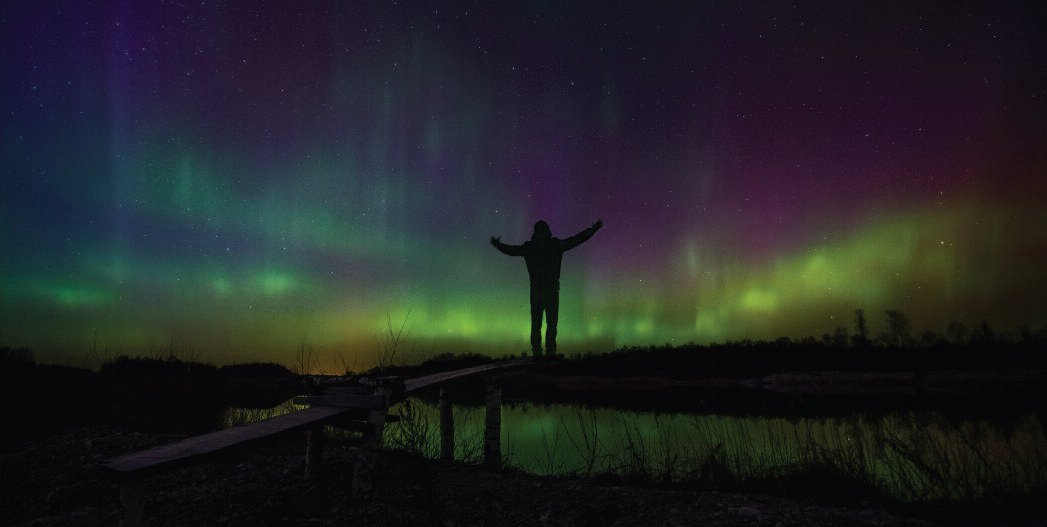 Me standing in front of very strong aurora display. The light seemed to penetrate my entire body. Veleniškiai quarry, Biržai region. March, 2015.