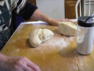 The dough is transferred to a floured pastry board.