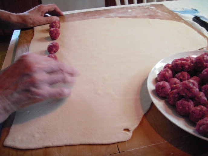 Mass production! Laying out the meatballs on the assembly line.