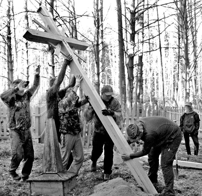 Many hands make for light work. Mission: Siberia team members erect a cross in honor of Lithuanian deportees in the Tomsk region of Russia.