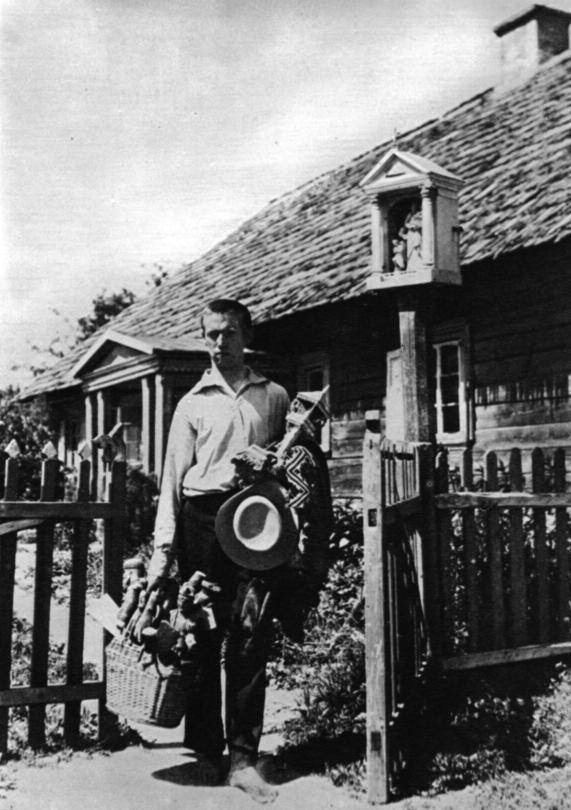 Balys as a young man carrying works of folk art in Sidariai.