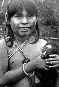 In Amazonia, little girls play with tamed wild animals instead of dolls. This Urudan girl holds a baby spider monkey. Other popular pets include the raccoon-like coati mundi, terecay turtles, and various birds. Rondonia, Brazil, 1973.